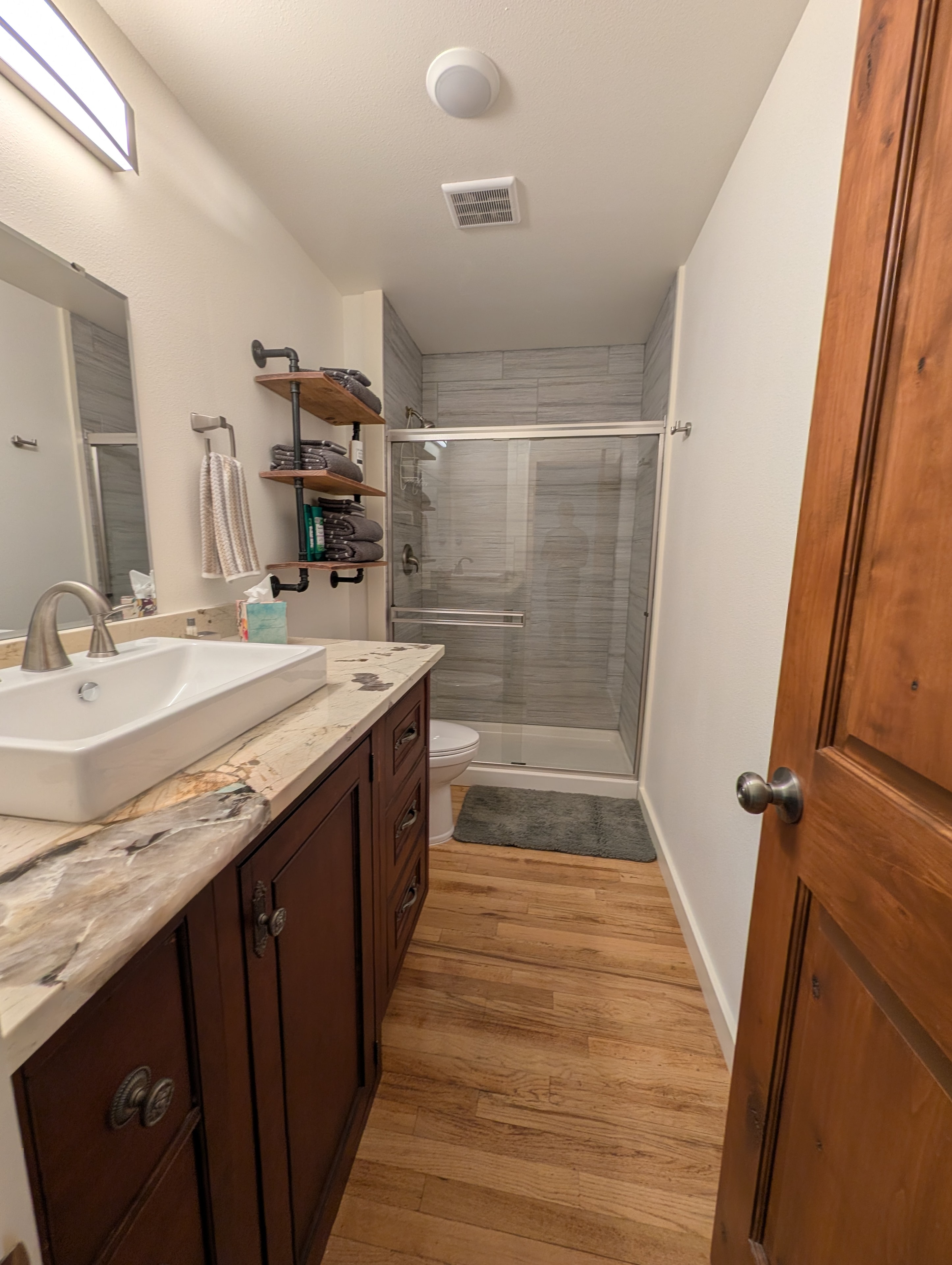 Second full bathroom with marble vanity and walk-in shower
