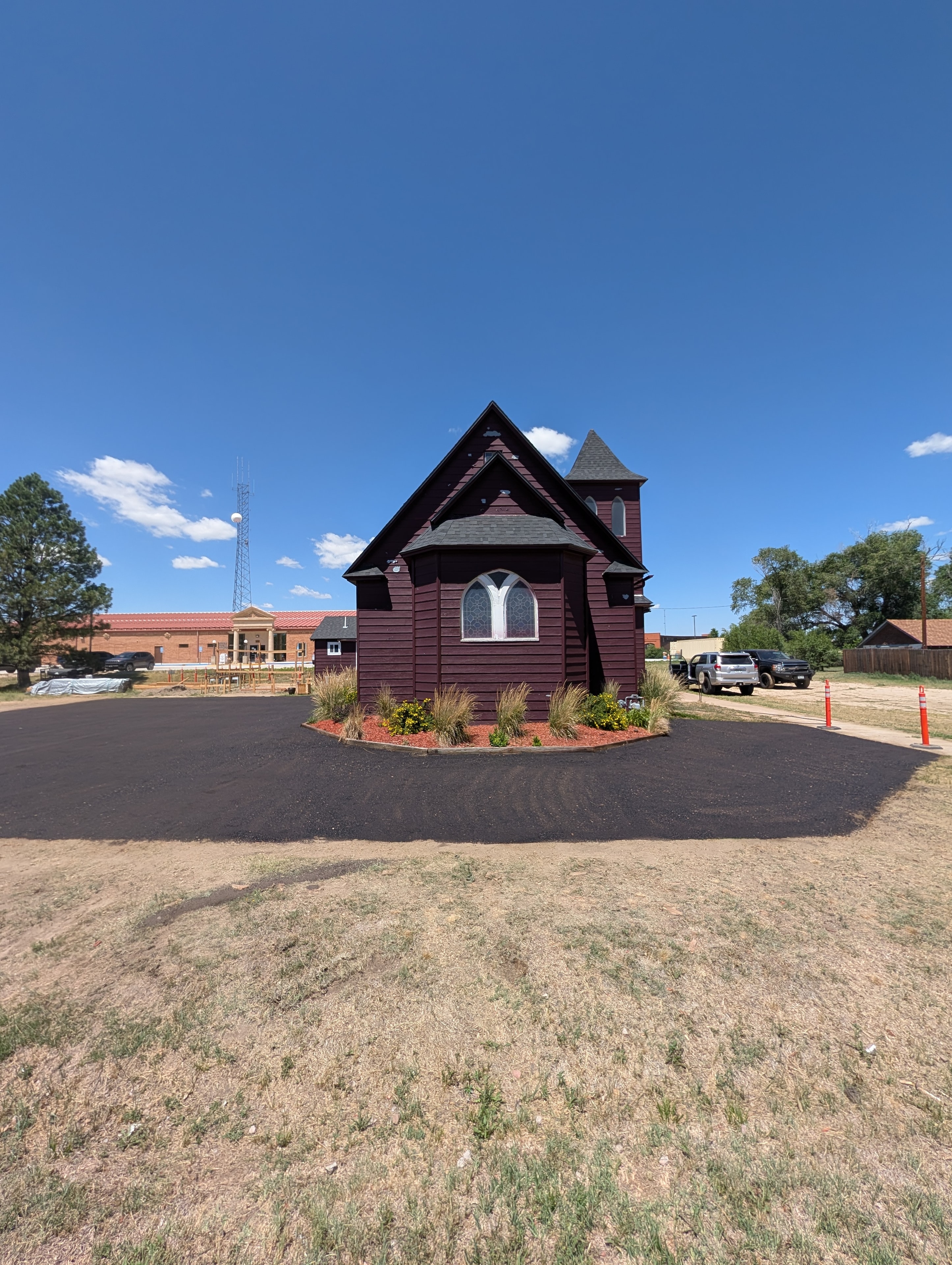 Accessible side entrance ramp with garden beds and parking lot view