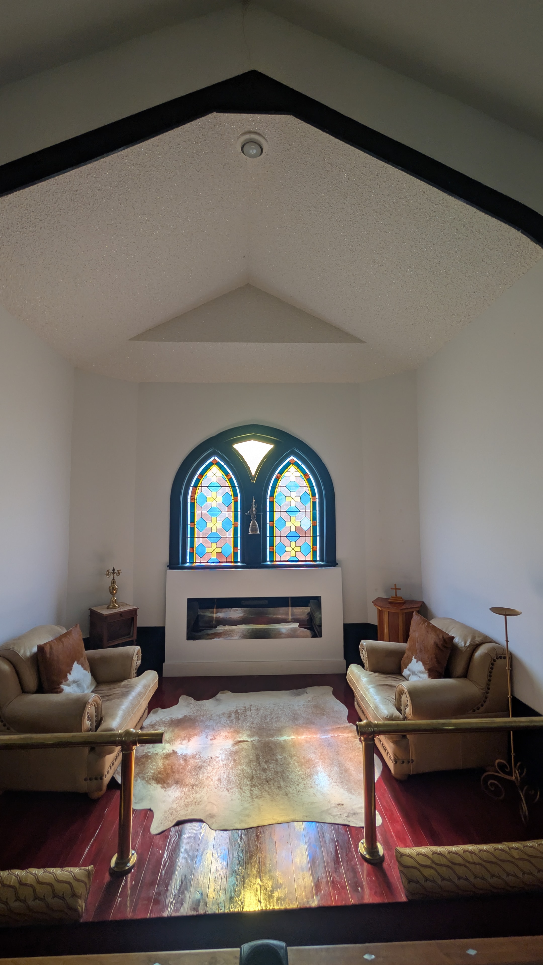 Full kitchen with marble island, stainless appliances, and stained glass windows